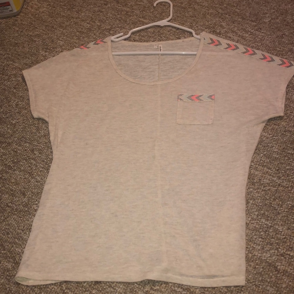A shirt with colors on the sides of the arm
